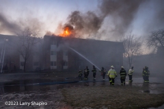 Flames break through the roof after breaching a fire wall. Larry Shapiro photo