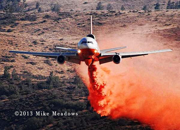 DC-10 dropping fire retardant at wildfire