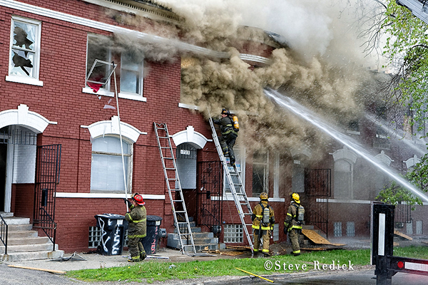 Detroit firemen fighting vacant building fire