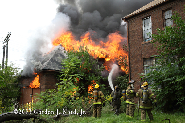 Detroit firemen battle vacant house fire