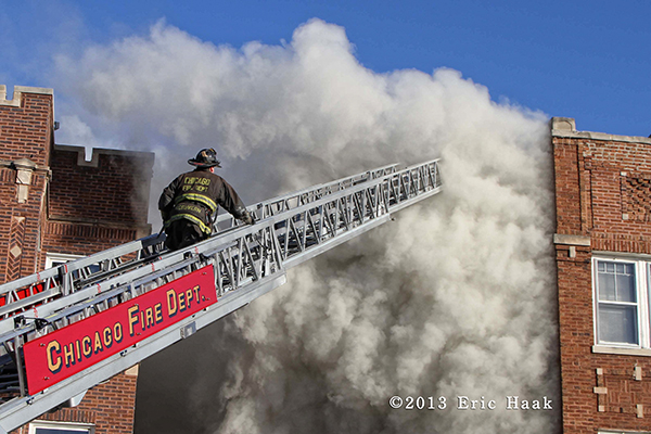 Chicago fireman on ladder with massive smoke at fire scene