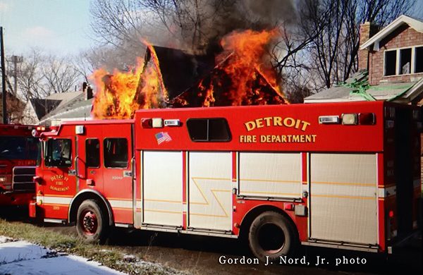 Detroit firemen battle vacant house fire at night