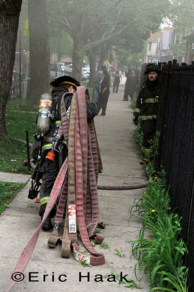Chicago firemen battle fire in two-flat house