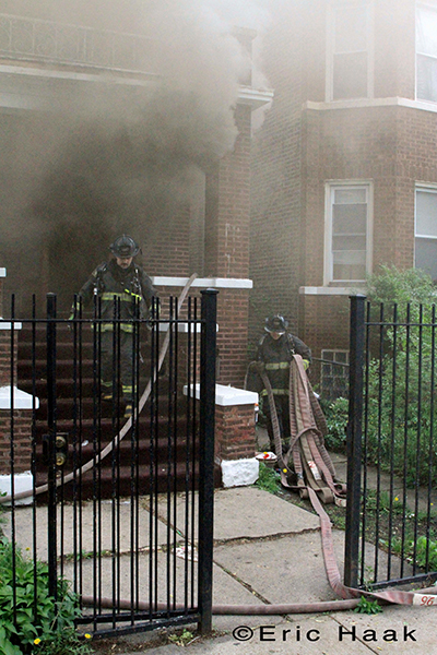 Chicago firemen battle fire in two-flat house