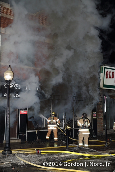 firemen battle smokey commercial fire at night
