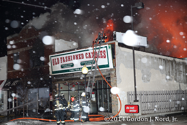 firemen battle commercial fire in snow