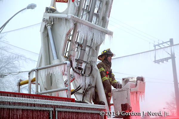 fireman with ice on ladder after fighting fire
