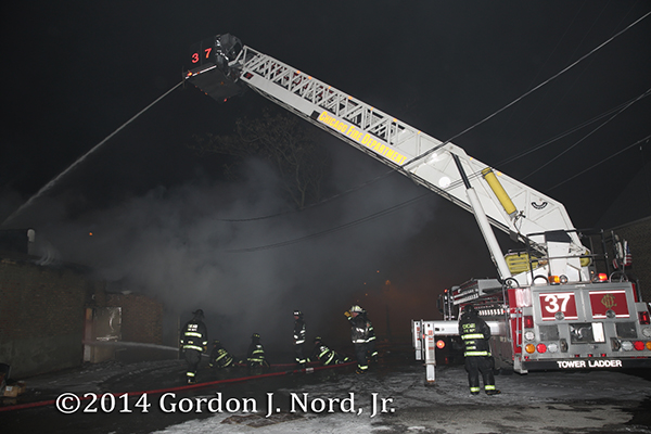 Chicago FD LTI Tower Ladder 37 working at a night fire scene