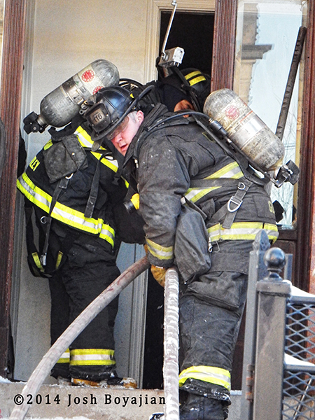 firefighters make entry with hose