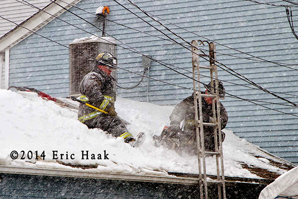 Chicago firemen fight house fire in snow storm