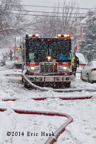 Chicago firemen fight house fire in snow storm