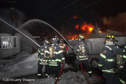 firemen at night with hose line