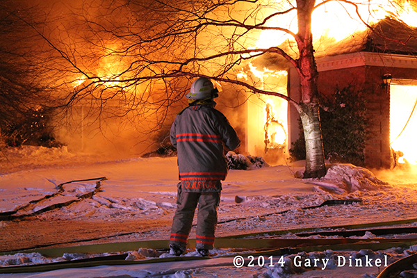chief fire officer at fully engulfed house fire at night