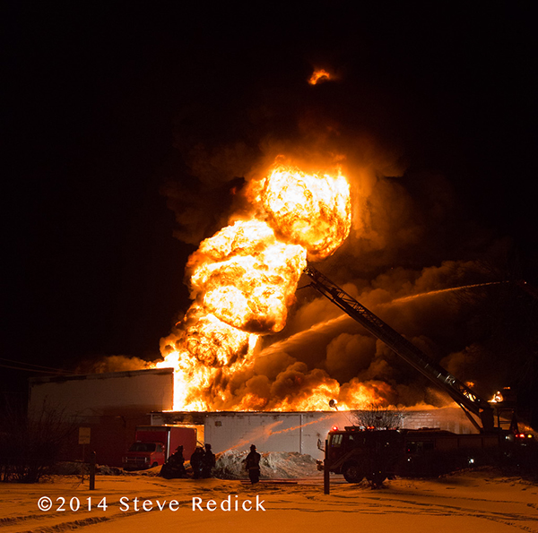massive fire ball from warehouse fire at night