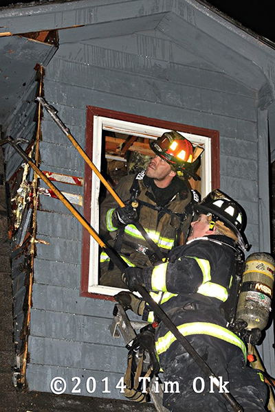 firemen doing overhaul at winter house fire