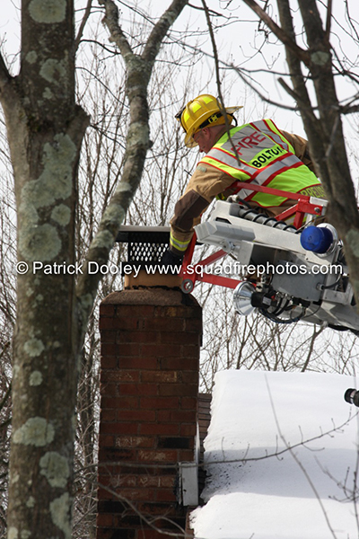 fireman inspects chimney after fire