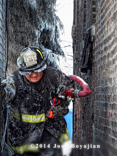 fireman covered with ice at fire scene