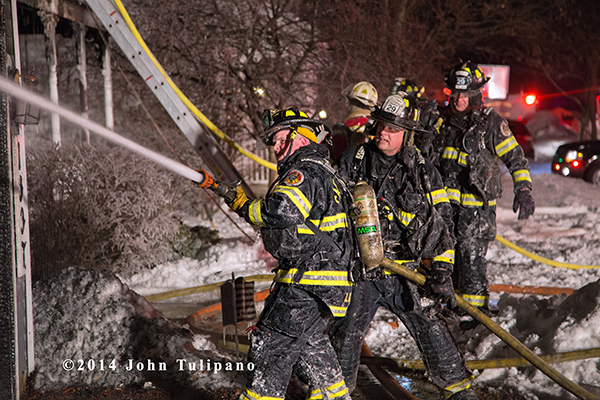 firemen covered with ice at house fire