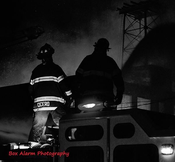 silhouette of firemen at night