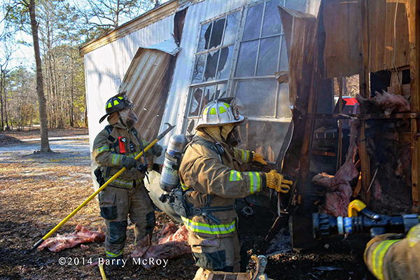 fireman battle mobile home fire
