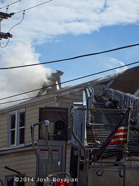 fireman on roof at fire scene