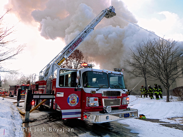 Smeal tower ladder at winter fire scene 