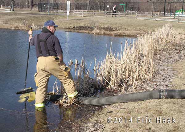 fireman drafting water from a pond