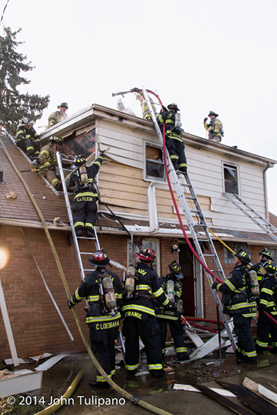 firemen overhaul house after fire