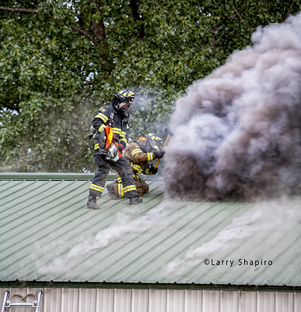 firemen ventilating corrugated roof