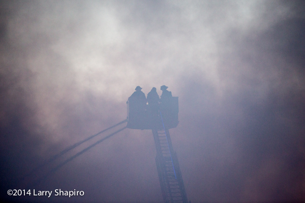 silhouette of firemen at fire scene