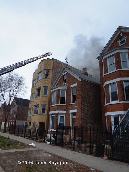 aerial ladder to roof of building on fire