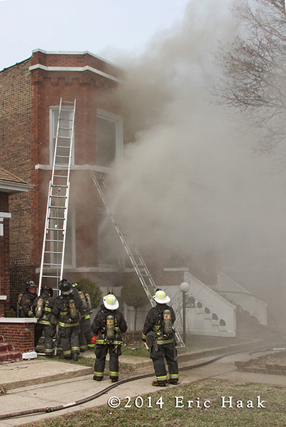 firemen at smokey building fire scene