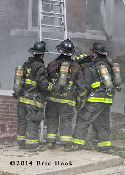 firemen at smokey building fire scene