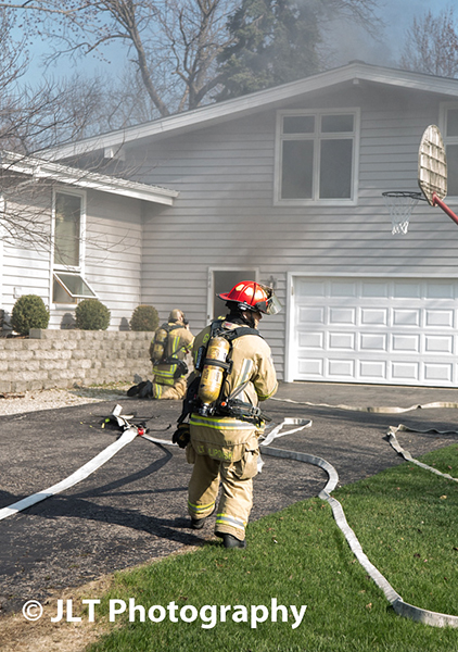 fireman entering house to extinguish fire
