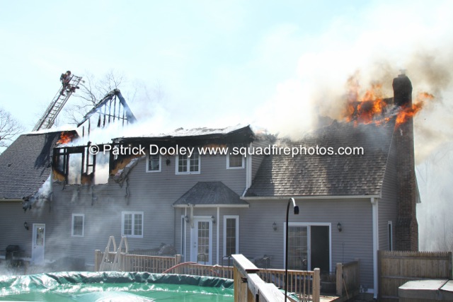 flames through roof at house fire