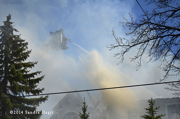tower ladder with smoke at fire scene