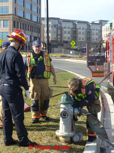 female firefighter at fire hydrant