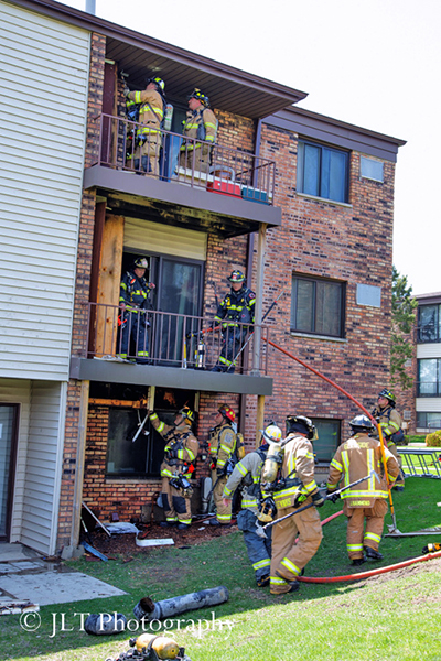 firefighters after fighting apartment building fire