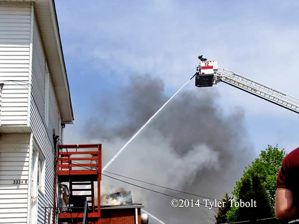 Pierce tower ladder working at fire scene