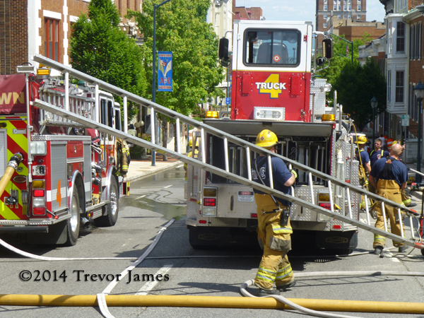 fireman putting ladder away after fire