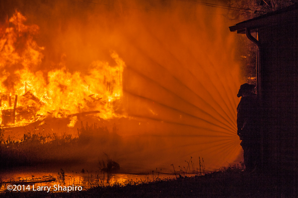 fireman silhouette with hose line and fire