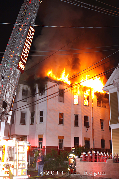 huge flames from Lawrence triple-decker