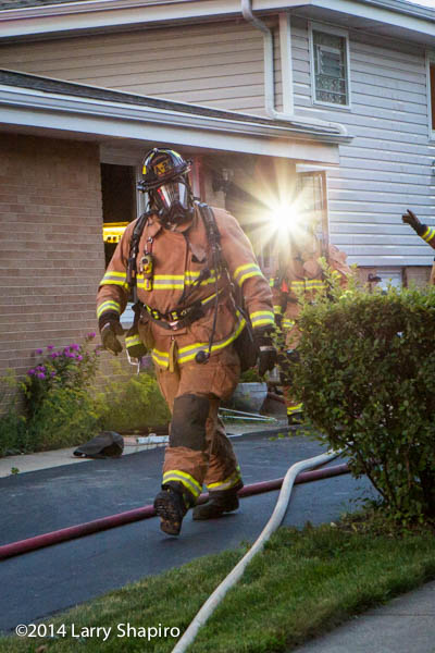 fireman walking at a fire scene with full PPE