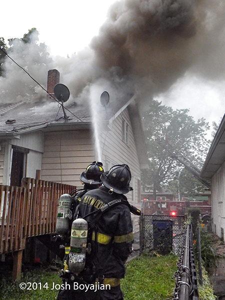 heavy smoke from roof of house fire