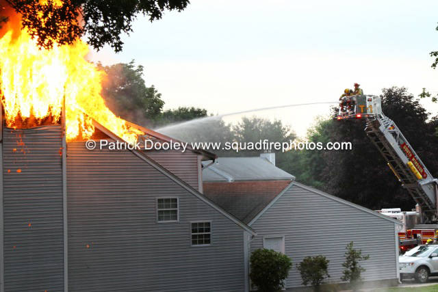 flames trough the roof of a townhouse