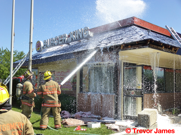 fireman using hose with foam on hot spots