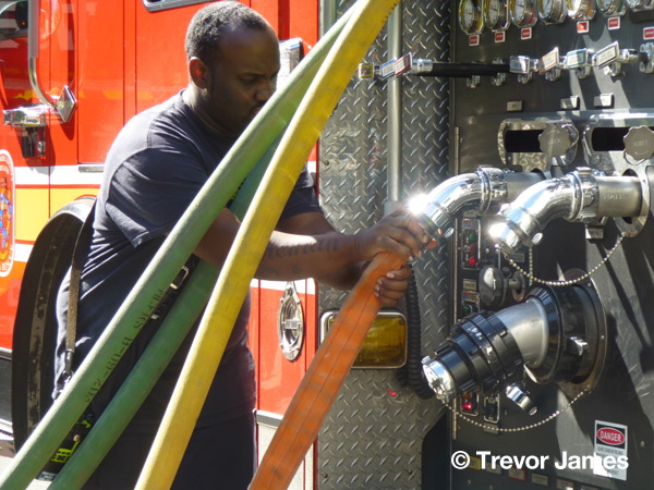 fireman with hose lines at pumper