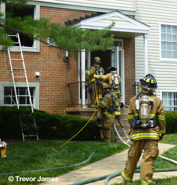 firemen with hose line at front door