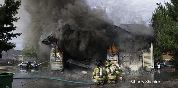 firefighters attack a garage fire