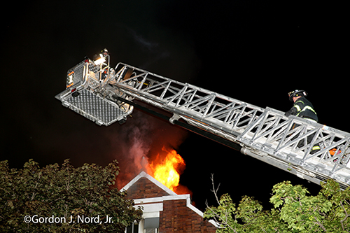E-ONE tower ladder working at night fire scene